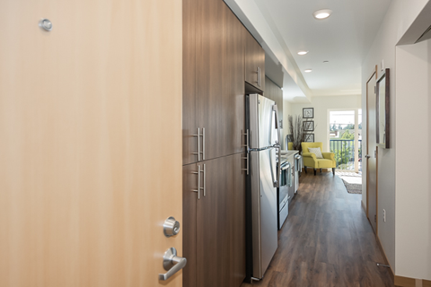 a kitchen with a refrigerator and a stove in a house
