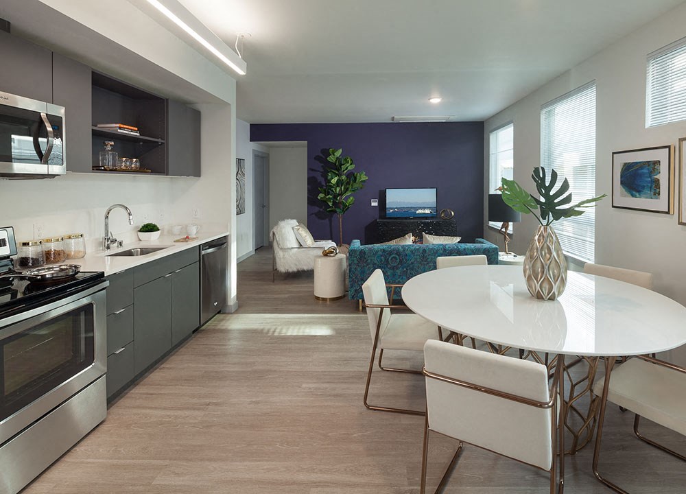 a kitchen and dining room with a table and chairs