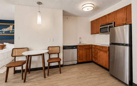 A kitchen with a table and chairs.