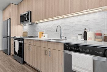 a kitchen with a stove top oven next to a sink