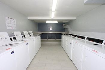 A laundromat with rows of washers and dryers.