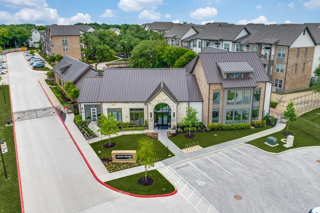 A parking lot in front of a building with a red curb.