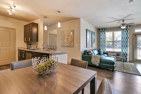 A modern dining room with a wooden table and chairs.