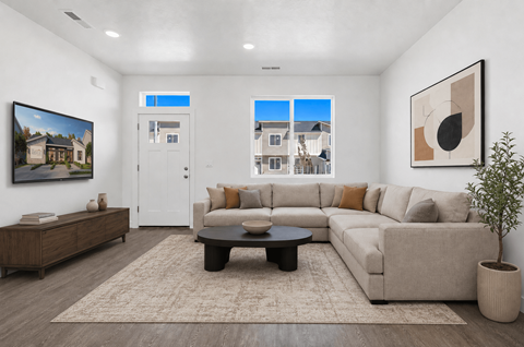 A living room with a couch, coffee table, and a painting on the wall.