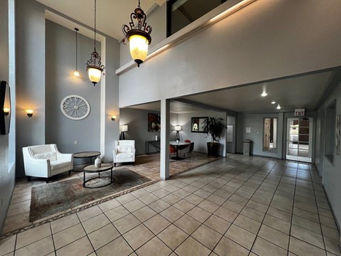 A living room with a white couch and a rug.