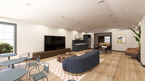 A living room with a grey sofa, a black television, and a wooden floor.