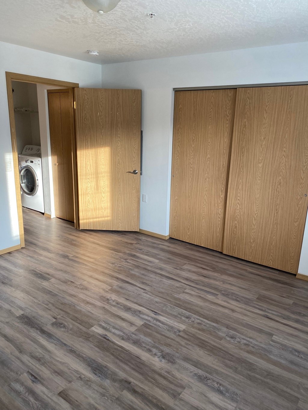 an empty room with a washer and dryer in it