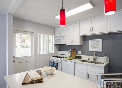 a kitchen with white cabinets and a white counter top