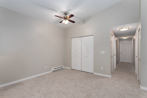 Novela Apartments Bedroom with Ceiling Fan and Closet Door