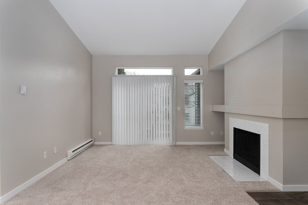 Novela Apartments Living Room with Fireplace and Patio Door