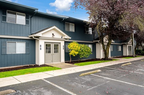 A blue building with a white door and windows.