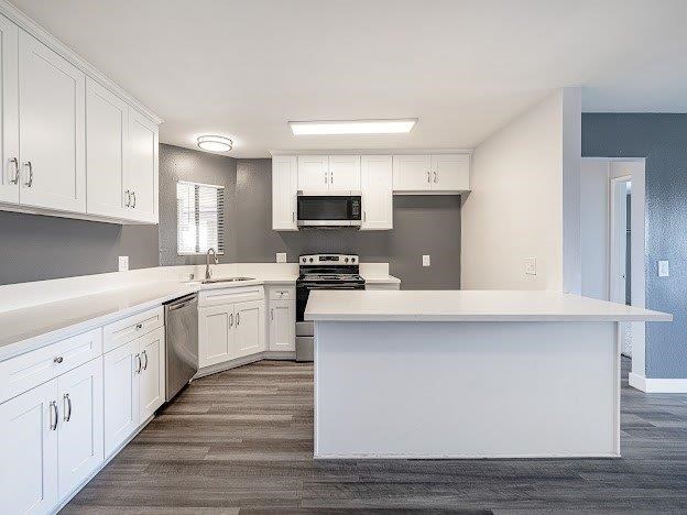 A modern kitchen with white cabinets and a large island.