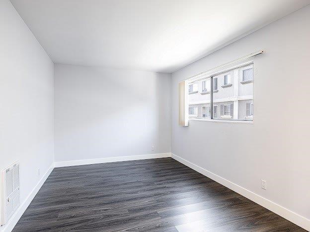 A room with a window and a radiator on the wall.