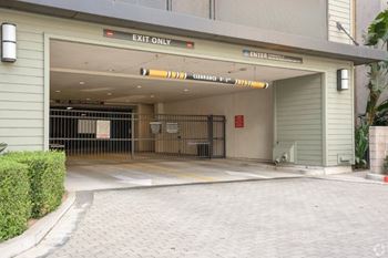 A parking garage entrance with a sign that says "EXIT ONLY".