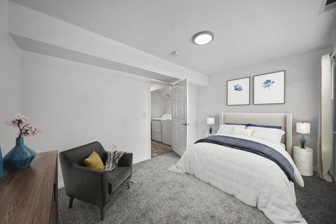 a bedroom with a medium sized bed and a chair in front of a window