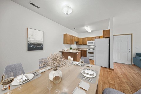 a dining room and kitchen with a table and chairs