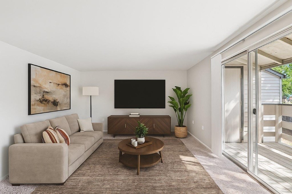 A living room with a couch, a coffee table, and a painting on the wall.