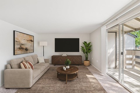 A living room with a couch, a coffee table, and a painting on the wall.