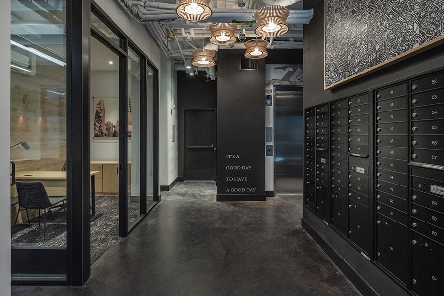 a view of the hallway with lockers and a sign that reads fta company tower