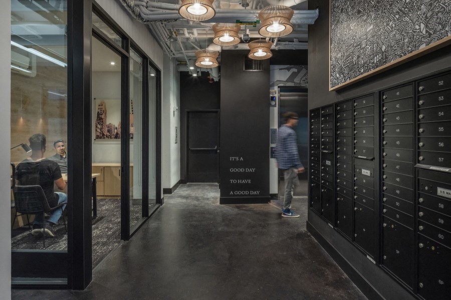 a view down the hallway of a large room with lockers and a sign that says f