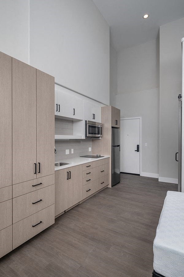 a kitchen with a stove top oven next to a refrigerator
