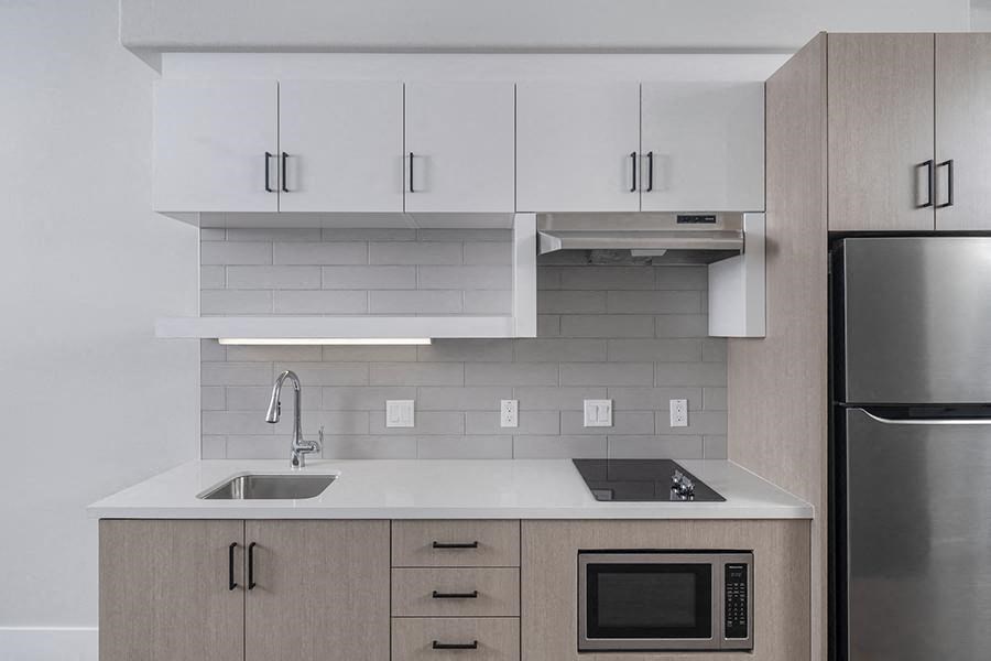 a kitchen with a sink microwave and refrigerator