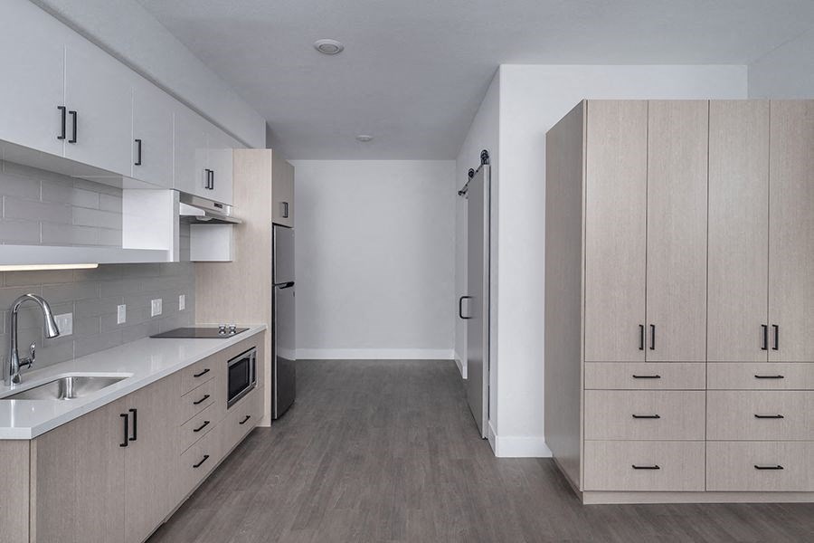 a kitchen with a sink and a refrigerator