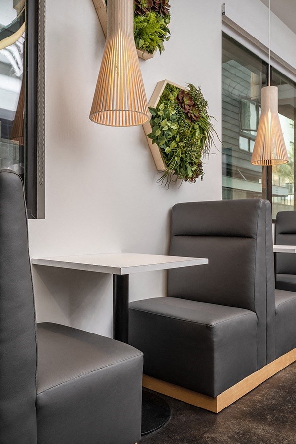 a couple of black chairs and a white table in a room