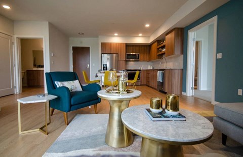 a kitchen and living room with a table and chairs