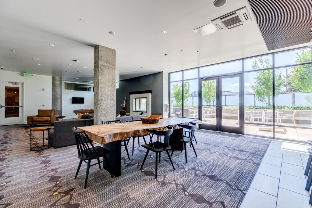 a large dining room with a wooden table and chairs