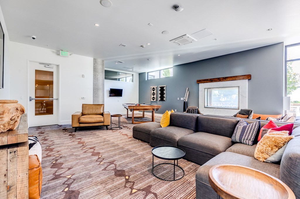 a living room with couches and chairs and a fireplace