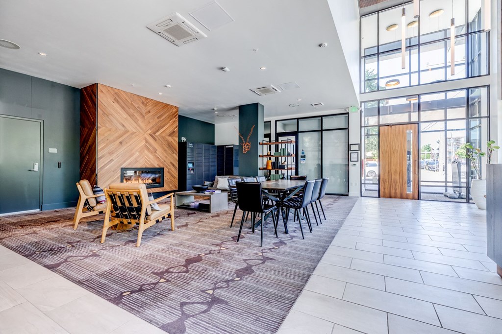 a large room with a table and chairs and a fireplace