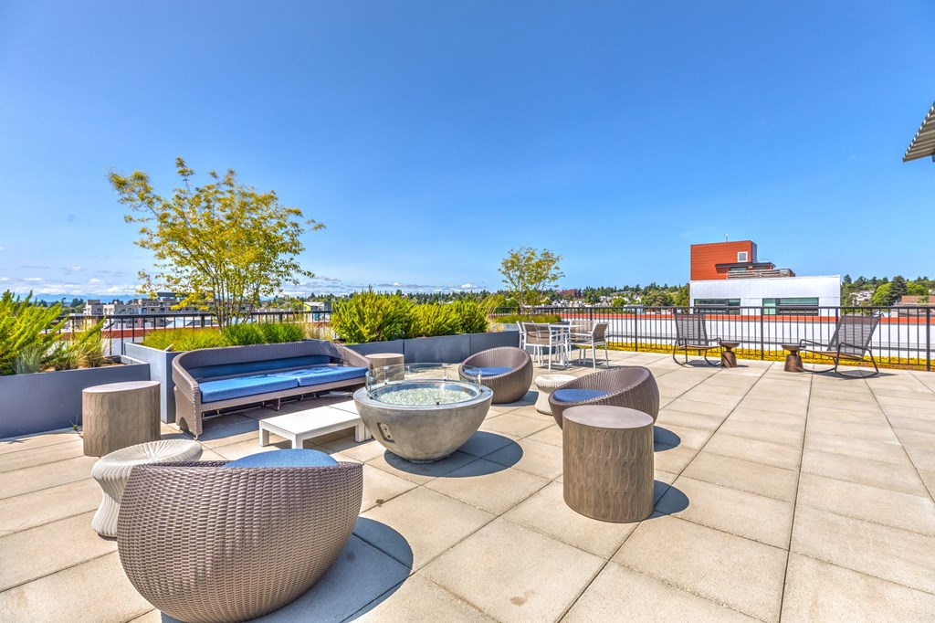 the terrace lounge with tables and chairs and views of the city