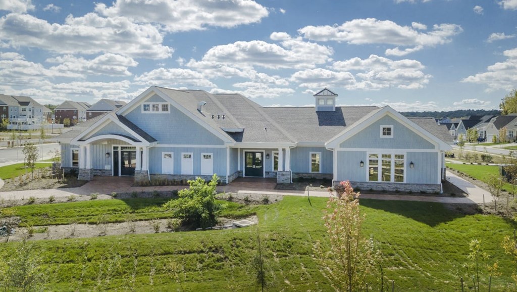 a large white house with a yard in front of it
