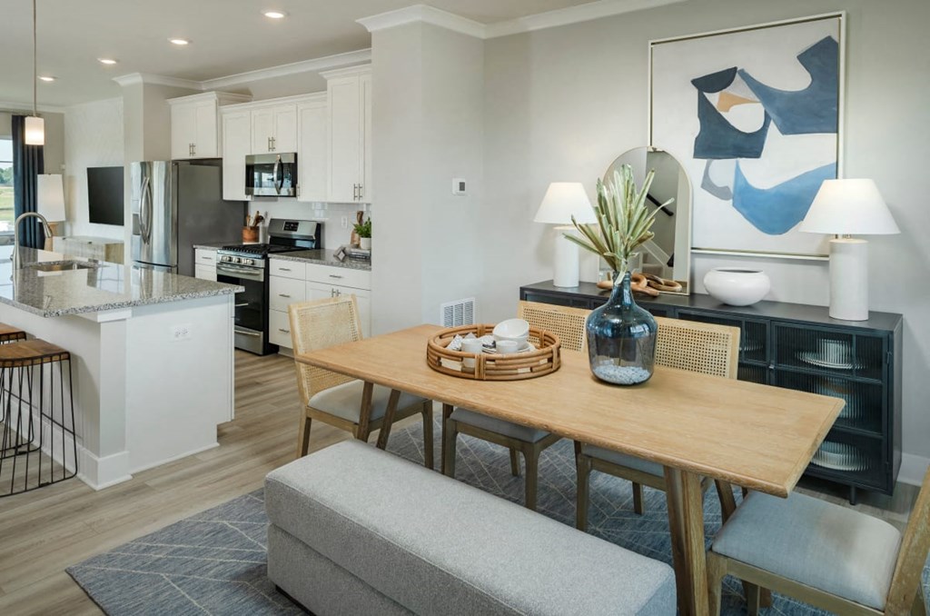 a living room and kitchen with a dining room table
