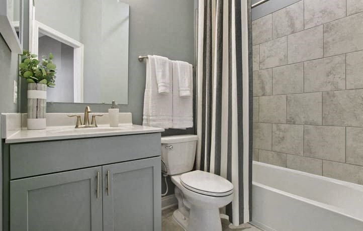 a bathroom with a toilet and a sink and a shower