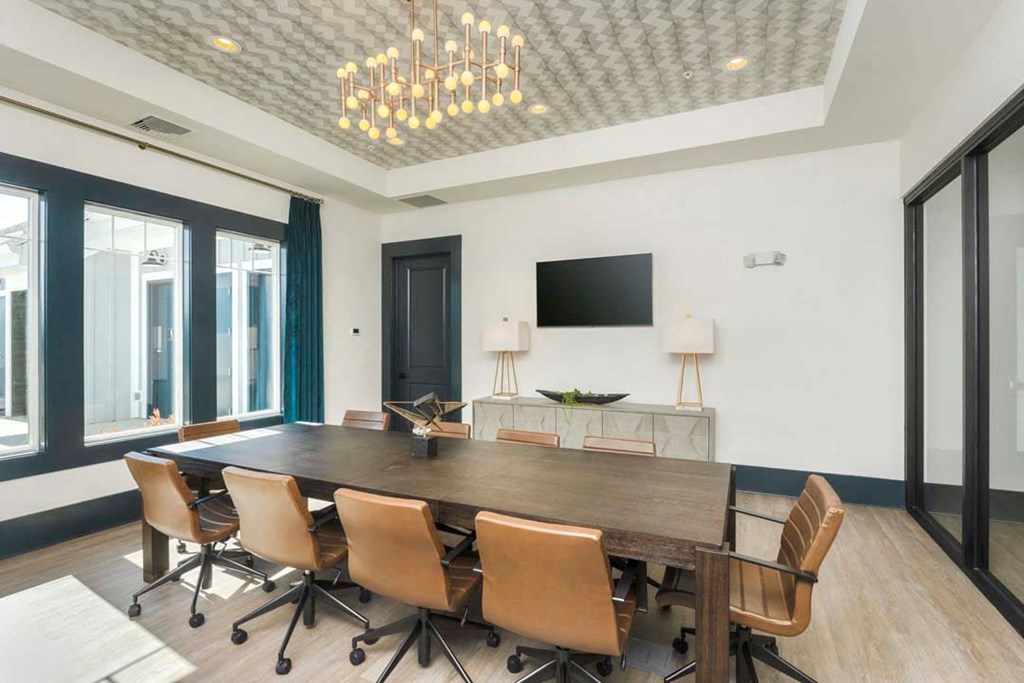 a conference room with a long wooden table and chairs