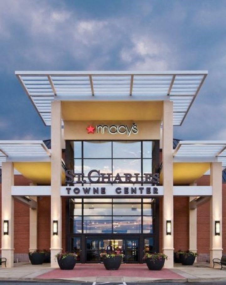 the facade of a town center building with a sign on it