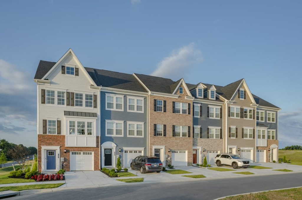an image of an apartment building with cars parked in front of it