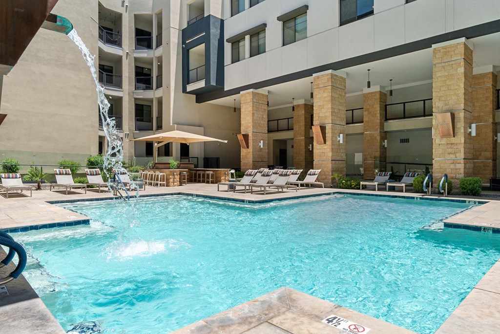 a swimming pool with a building in the background