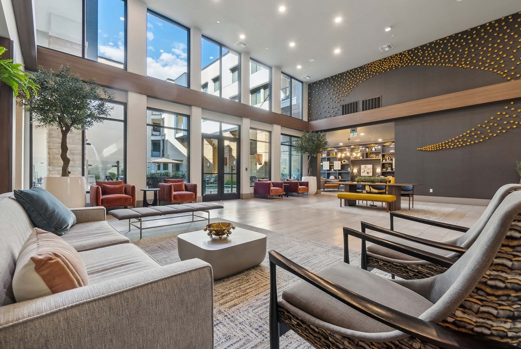 a large lobby with couches and chairs and large windows