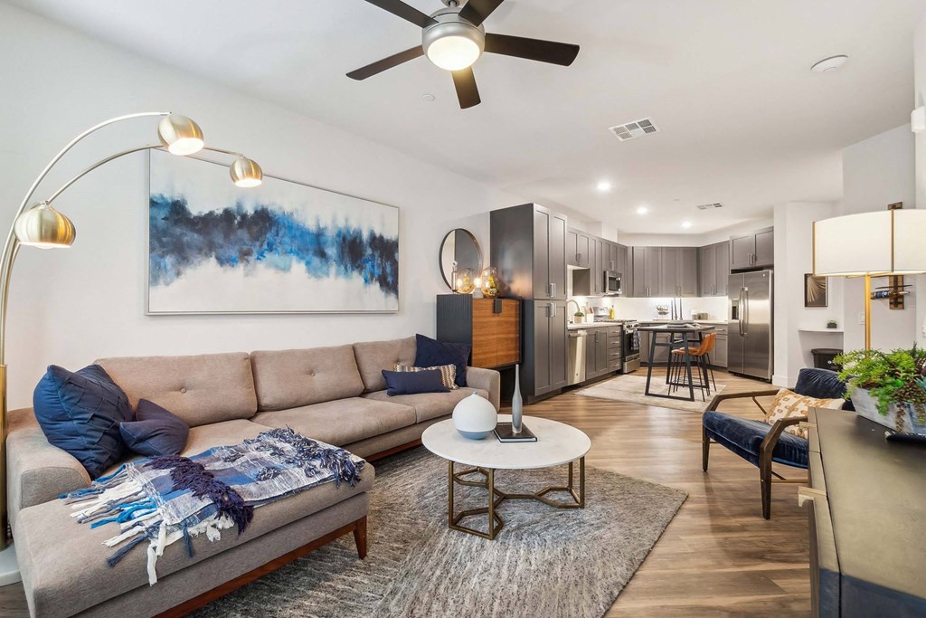 a living room with a couch and a ceiling fan