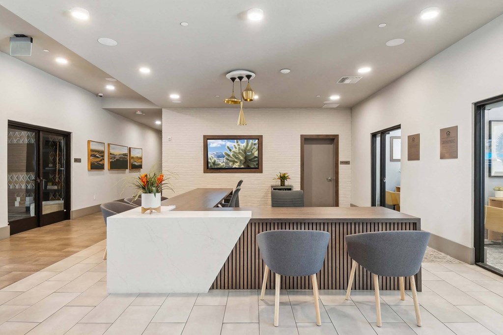 a kitchen with a counter top and chairs