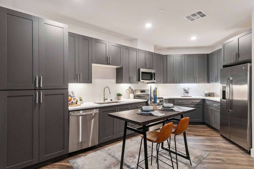 a kitchen with stainless steel appliances and a table