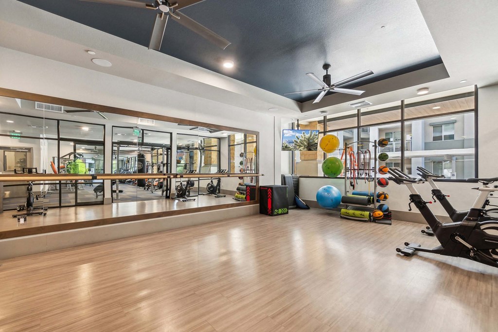 a home gym with weights and mirrors on the wall
