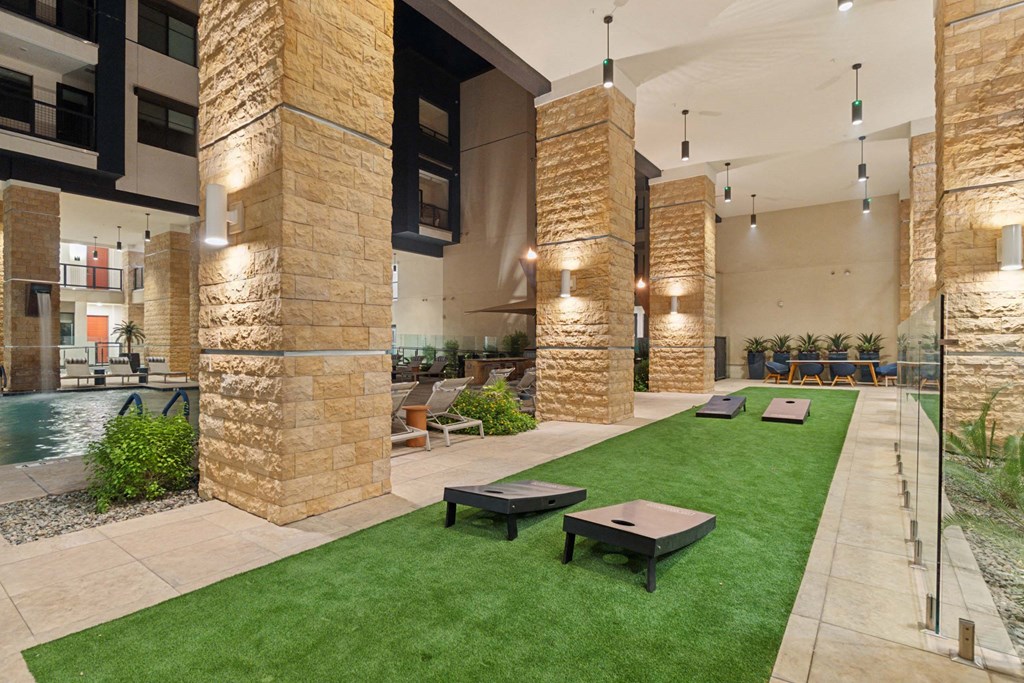 a large lobby with a pool and grass