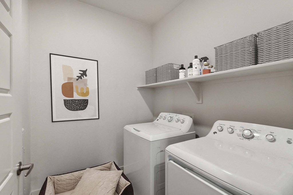 a white washer and dryer in a white laundry room