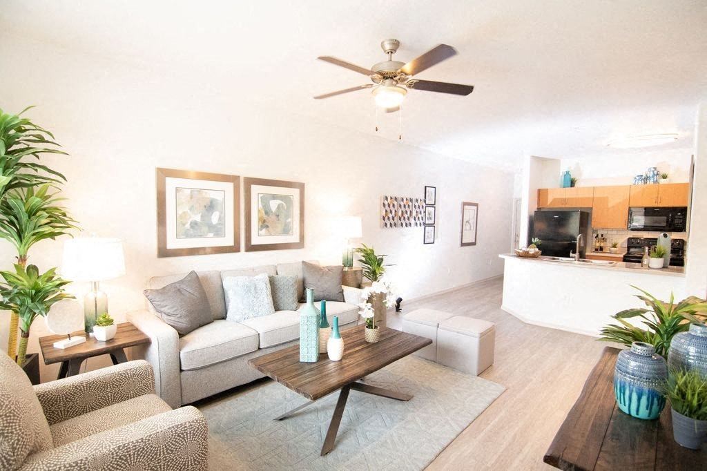 a living room with a couch and a ceiling fan