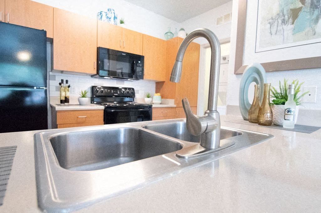 a kitchen with a sink and a faucet