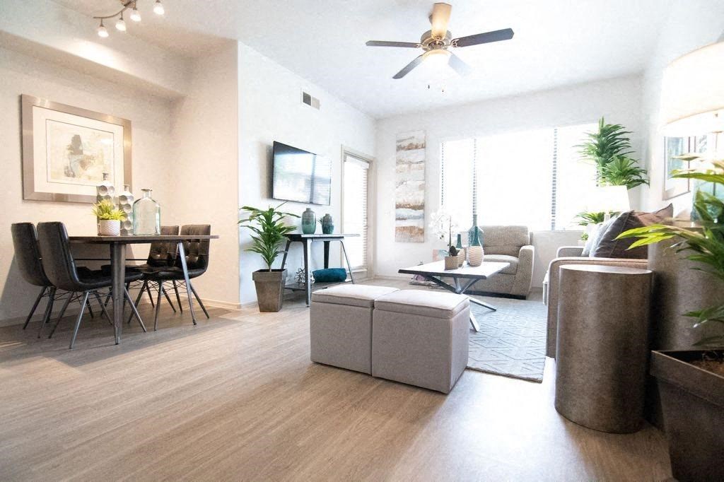 a living room and dining room with a ceiling fan